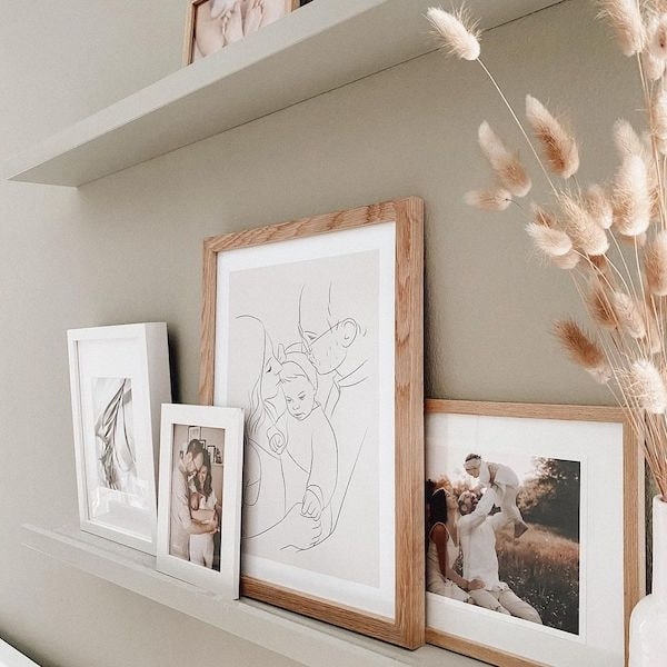 Photo wall with family photos, including a Line Art drawing of a young family, Instagram post by @adriane